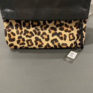 Clutch zippers and folds over